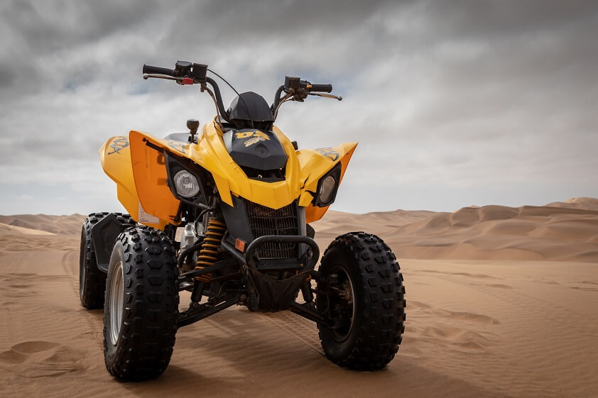 Yellow and Black Can-Am DS 250 ATV on Sand