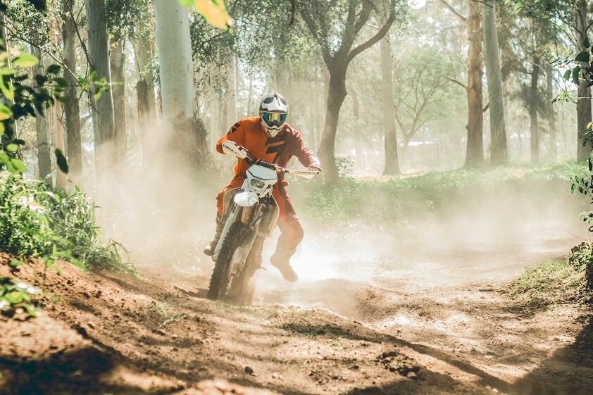 Dirt Bike Rider Wearing Orange Riding White Motorcycle