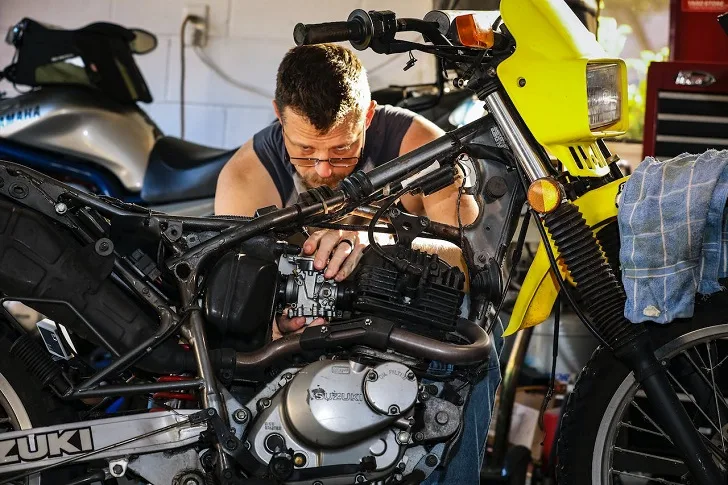 Man Fixing Dirt Bike Carburetor