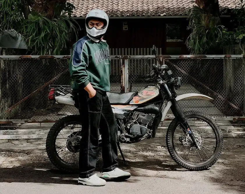 Man Standing Next to Suzuki Motorcycle