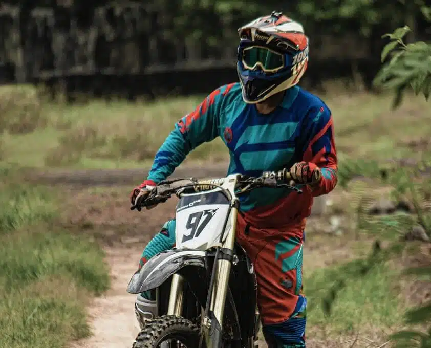 Man With Dirt Bike Parked on Footpath