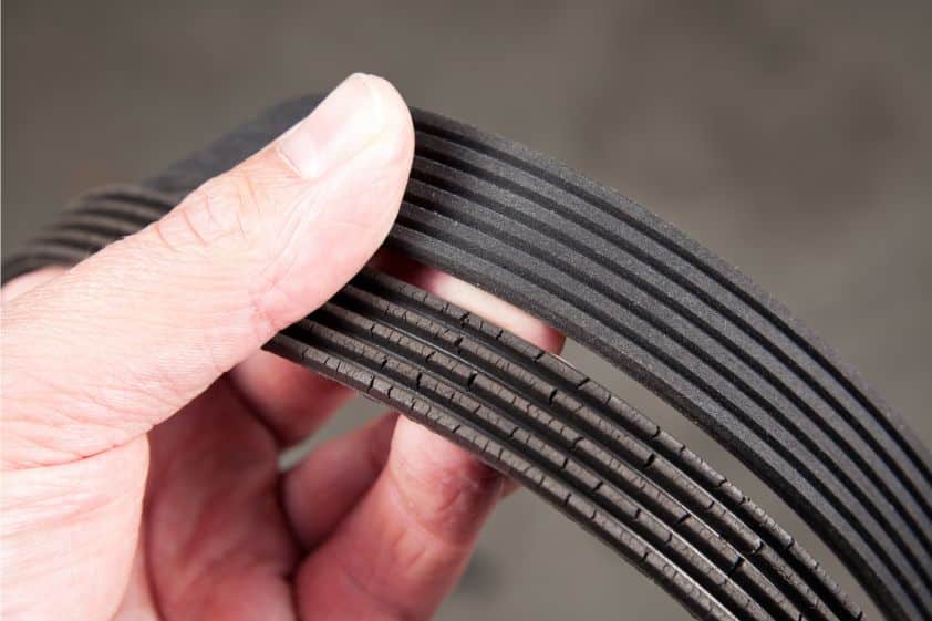 Mechanic Holding Old and New Serpentine Belts