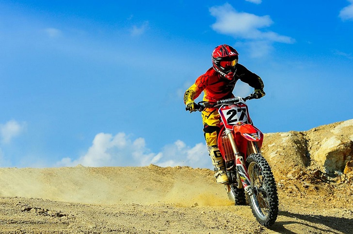 Person Riding Motocross Dirt Bike Under Blue Sky