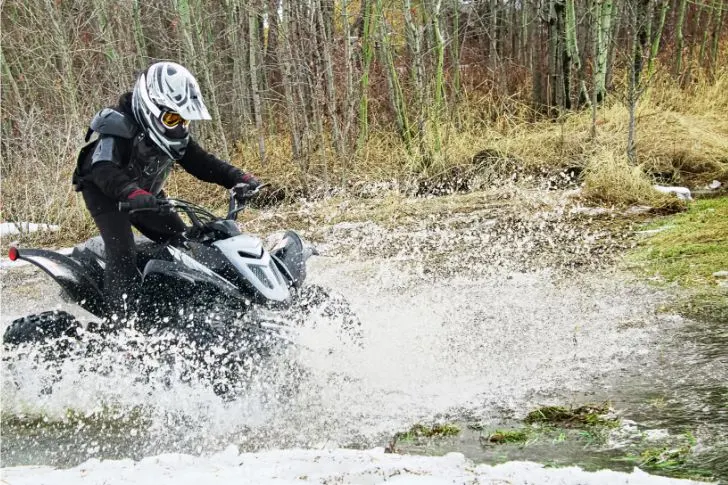 Riding ATV Quad Through Water