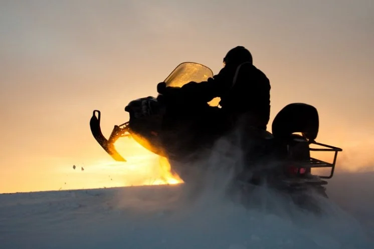 Riding Snowmobile During Sunset