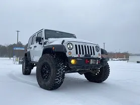 White Jeep Wrangler Rubicon in Snowy Parking Lot