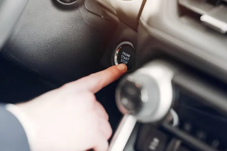 Person Pressing Car Ignition Button